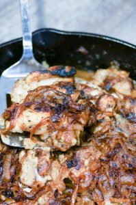 Easy French Onion Chicken tops juicy chicken thighs with sweet and savory caramelized onions. One pan, 7 ingredients, weeknight dinner. #onepan #weeknightmeal #easydinner #frenchonion