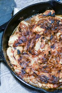 Easy French Onion Chicken tops juicy chicken thighs with sweet and savory caramelized onions. One pan, 7 ingredients, weeknight dinner. #onepan #weeknightmeal #easydinner #frenchonion