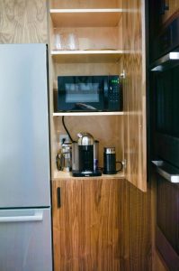 Hiding appliances in the kitchen is a great way to keep a clean, modern aesthetic. #hiddenappliances #hiddenmicrowave #kitchenrenovation #whitecoatpinkapron