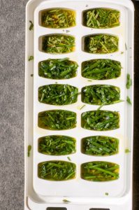 Herbs and olive oil in ice cube trays