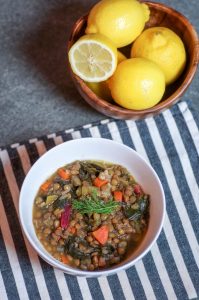 Easy Lentil Soup with lemon and greens is a hearty winter dish that will warm you through on the coldest days. #vegan #wfpb #lentilsoup #whitecoatpinkapron